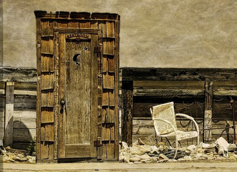 Why do outhouses have a moon or heart cutout on the doors?